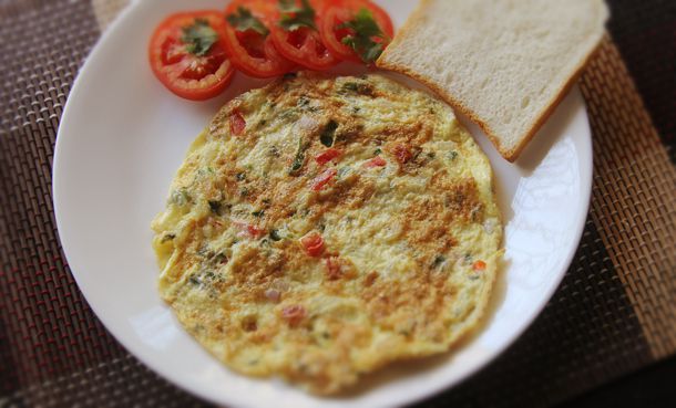 Indian Masala Omelet served with toast and sliced tomatoes