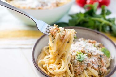 A fork swirling strands of pasta in Pesto alla Trapanese.