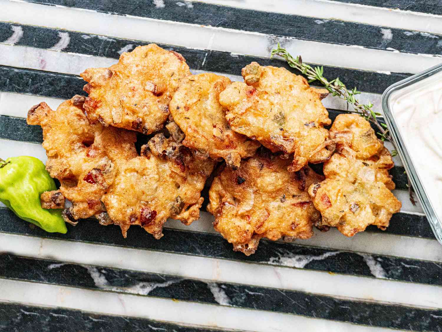 Savory fritters served with herbs and peppers.