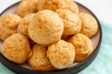 A pile of gougères resting on a plate