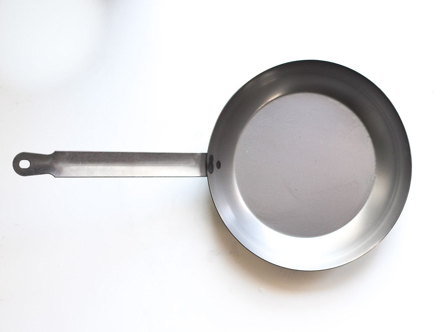 Vollrath carbon steel skillet on white surface