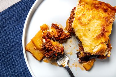 Overhead view of a fork of moussaka on a plate