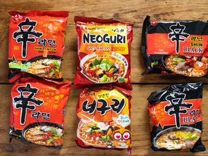 Overhead view of American and Korean versions of Nongshim instant noodles.
