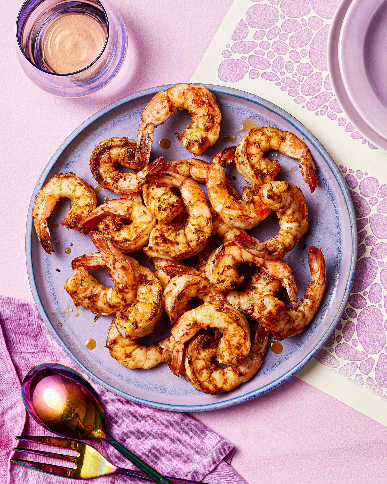 Cajun shrimp on a purple plate.
