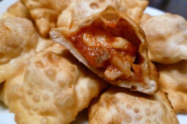 A plate of homemade pizza rolls filled with cheese and tomato sauce