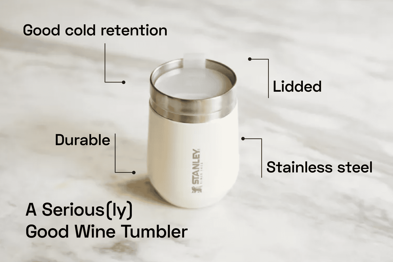 a white wine tumbler on a marble surface