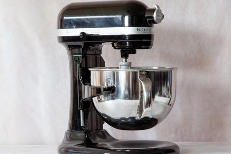 a black kitchenaid stand mixer on a marble surface