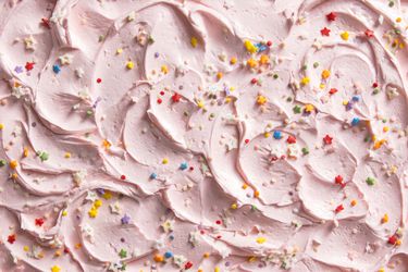 pink American buttercream topped with multi-colored sprinkles