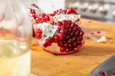 Side view of pomegranate on a cutting board