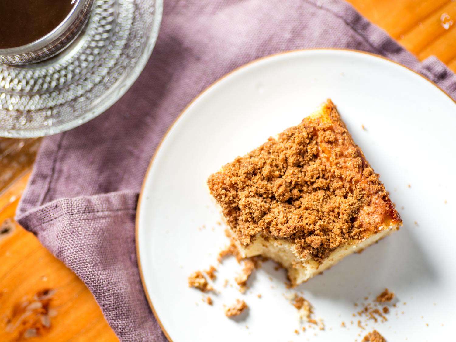 Overhead shot of plated coffee cake square missing a bite.