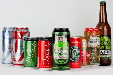 American canned ciders in a row in front of a white backround.