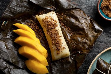 Overhead view of suman next to a cut mango topped with sugar