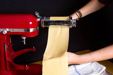 A sheet of fresh pasta being rolled out.