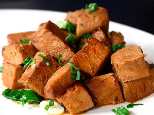 A plate of frozen tofu braised in soy sauce.