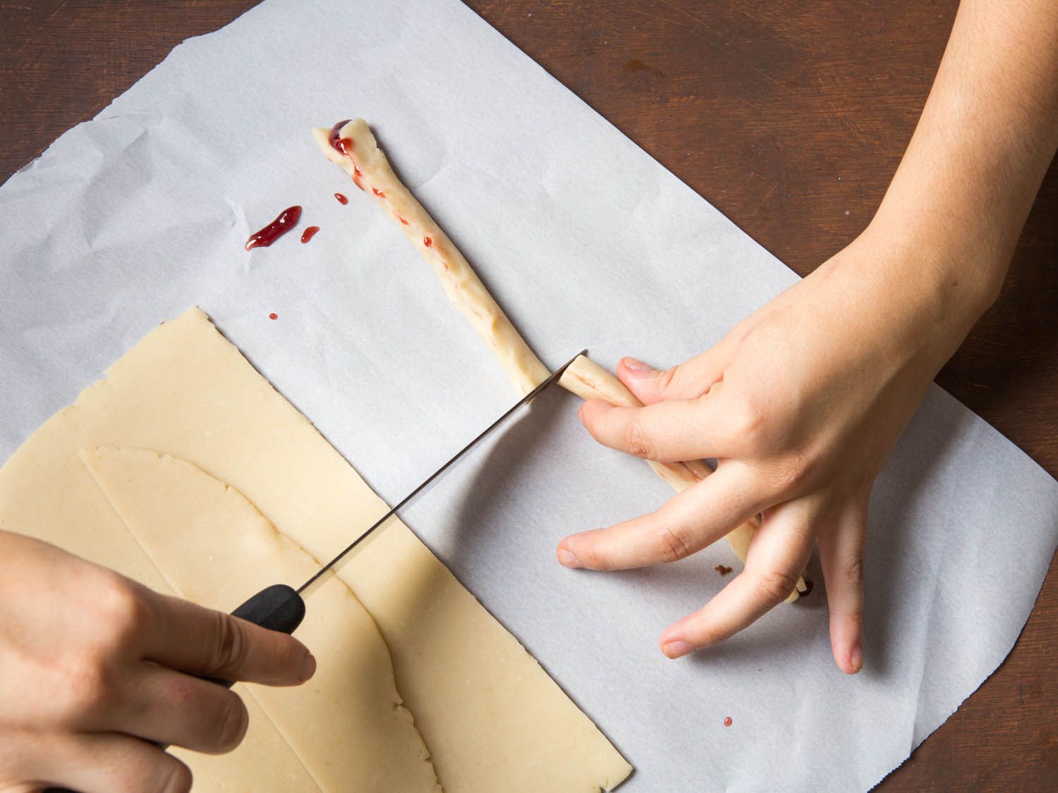 Cutting the with finger shortbread dough into two.