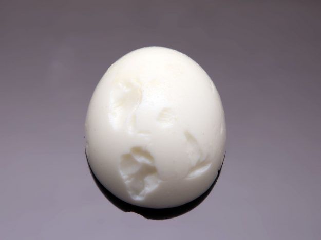 Boiled egg with pitted surface caused by starting egg in cold water.