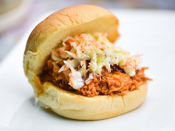 A barbecue sandwich topped with coleslaw.