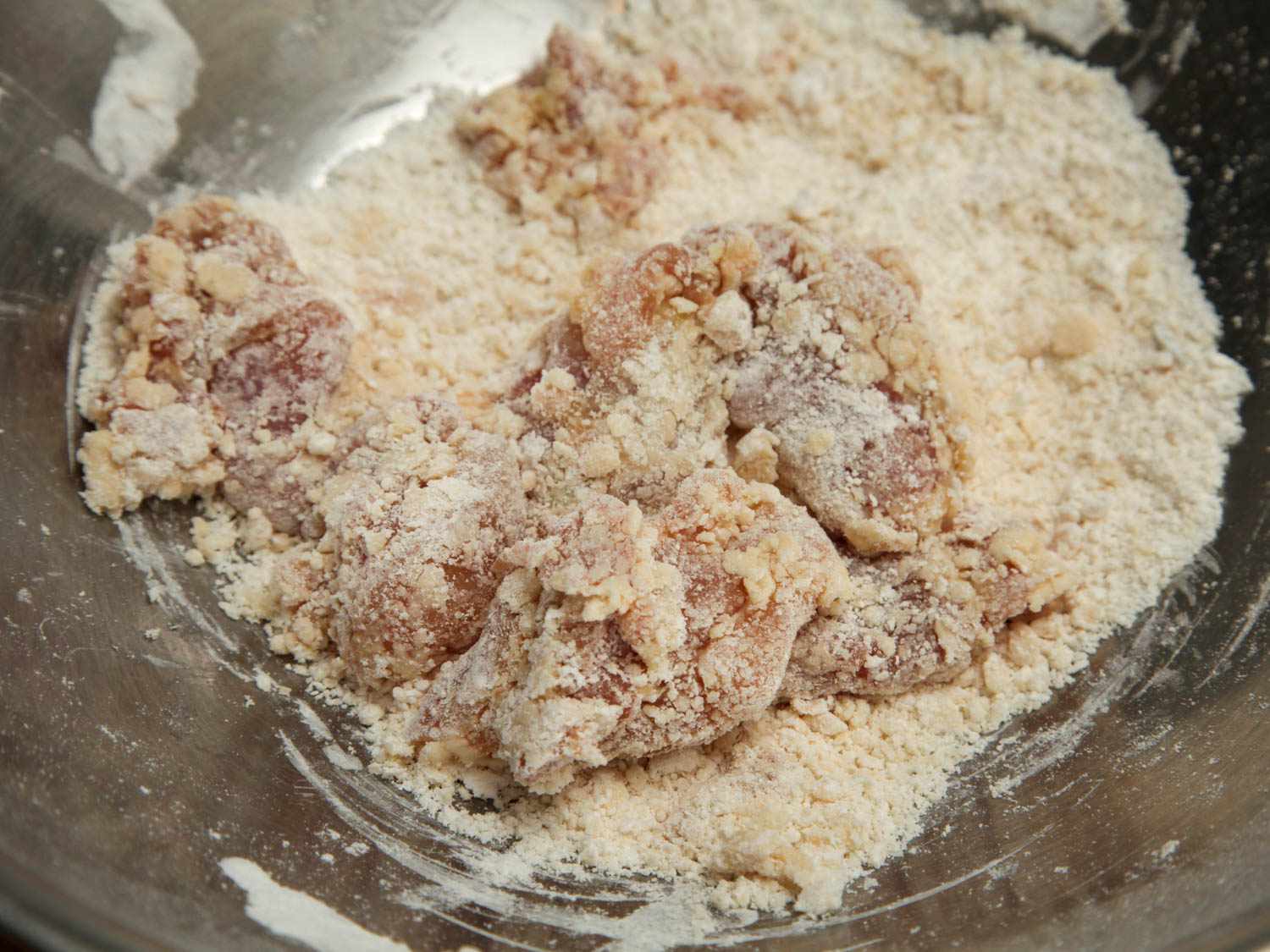 Boneless chicken thighs soaked in egg marinade and dredged in a semi-moist breading of flour and cornstarch.