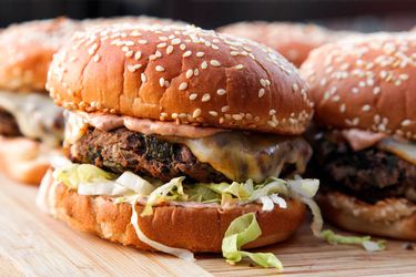 Black bean burgers on a bamboo cutting board.