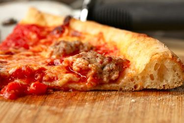 Side view of Italian sausage on pizza