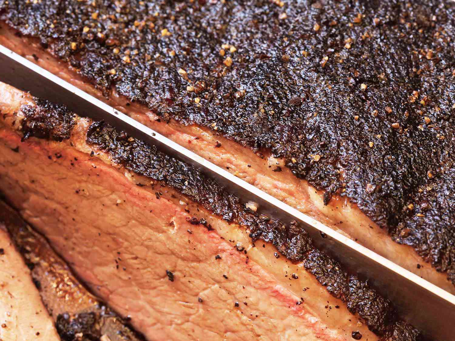 A close up of a sous vide brisket being cut.