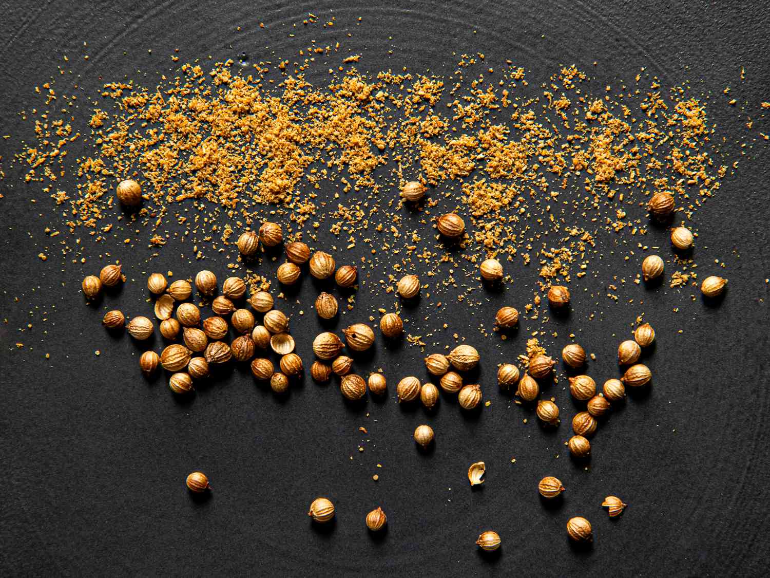 Cascade of ground coriander followed by whole coriander seeds.