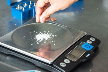 Measuring salt on a digital kitchen scale.