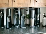 several soda makers on a kitchen countertop