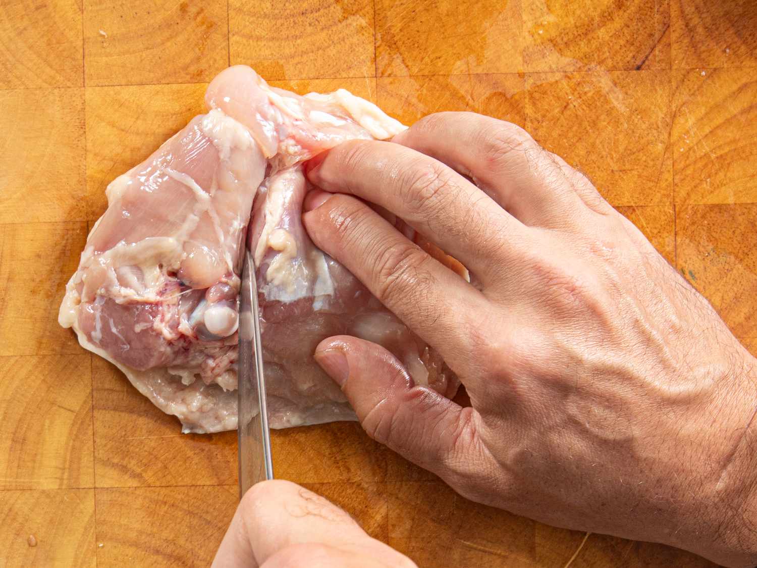 Overhead view of scoring the thigh along the bone