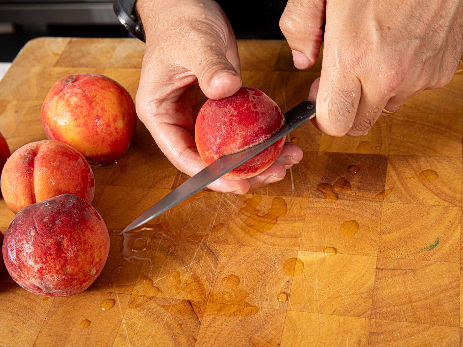 Overhead view of cutting a peach in half