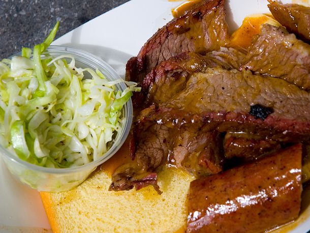 Barbecue and a side of coleslaw with cornbread.