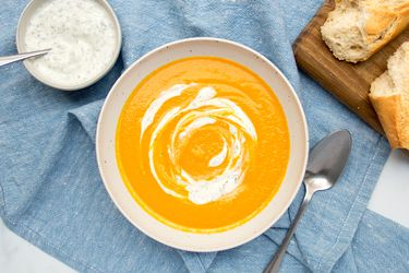 Carrot soup in a white bowl.