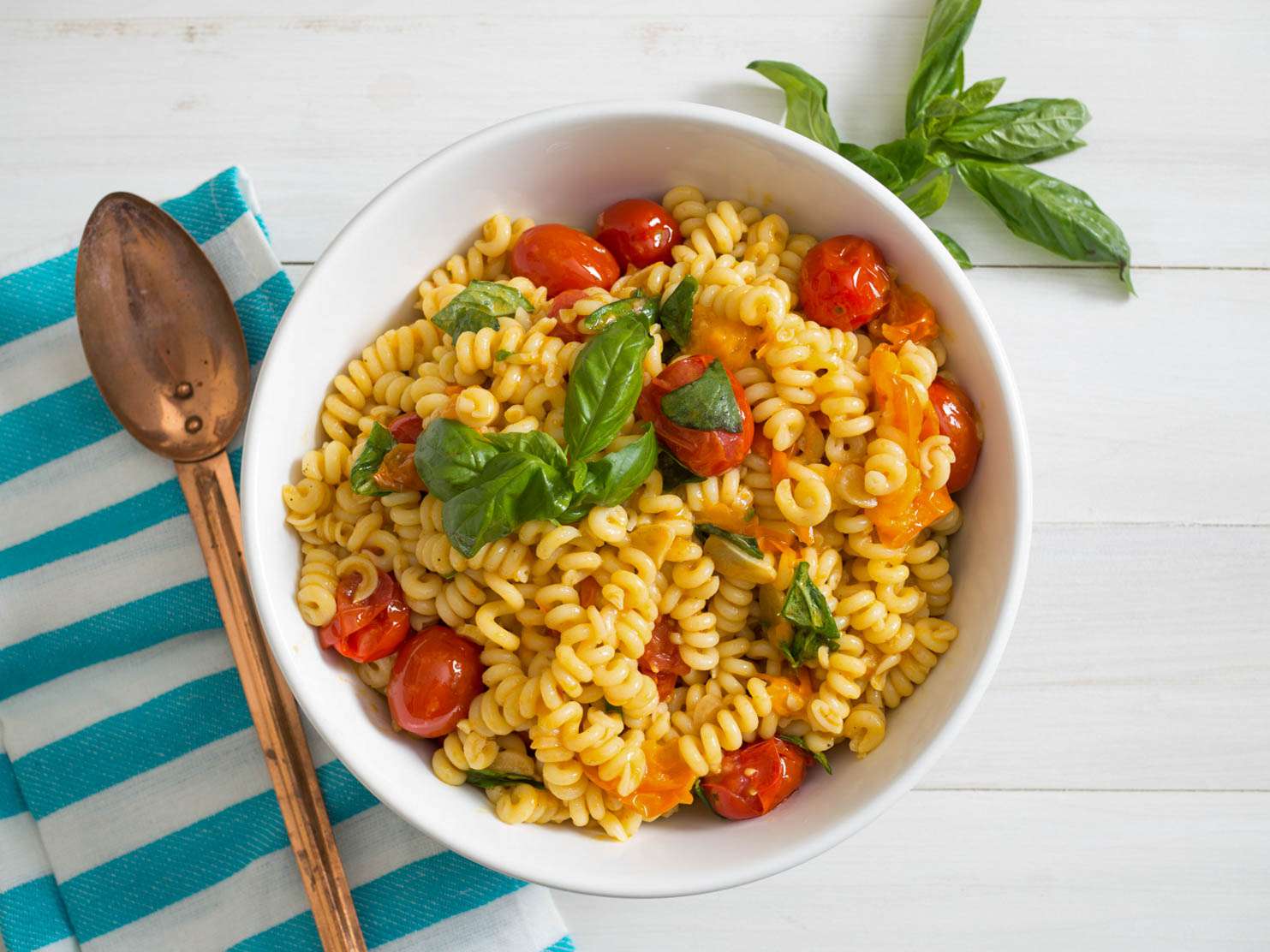 Cooked-until-bursting tomatoes make a beautiful sauce for this summery pasta salad.