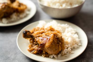 Chicken yassa on a bed of white rice.