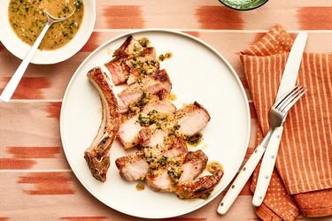 Overhead view of cut up porkchops with sauce