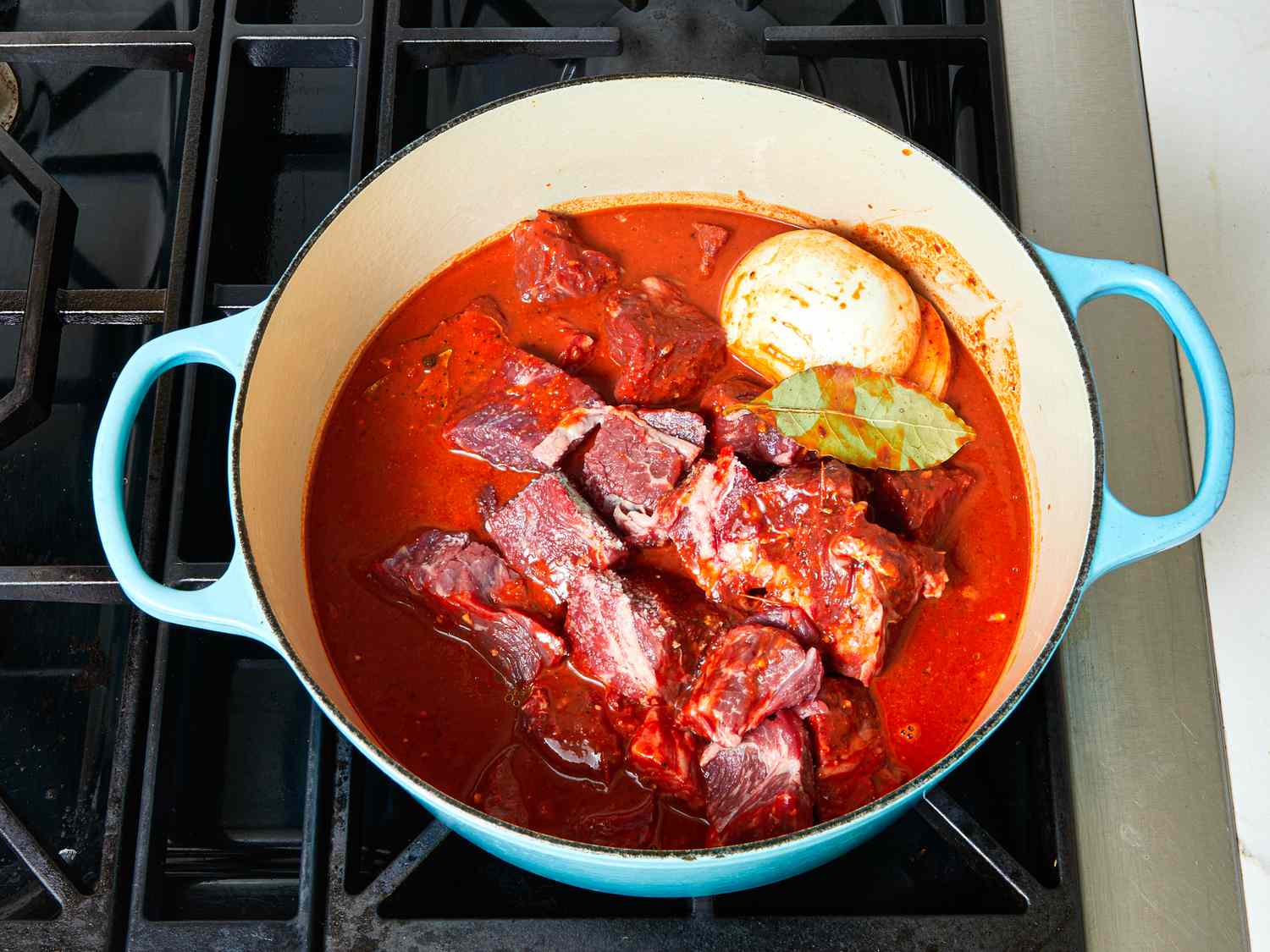 Overhead view of beef cooking in pot