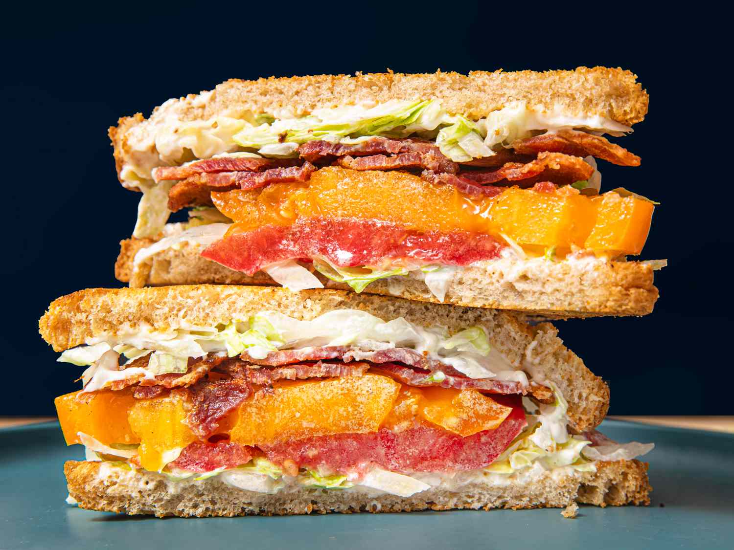 Two halves of a BLT stacked on top of each other