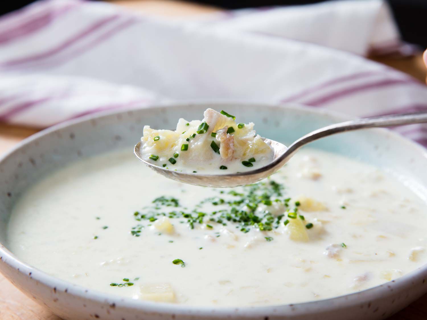 A spoonful of cullen skink being lifted from the bowl