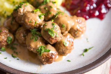 A plate with gravy-covered Swedish meatballs