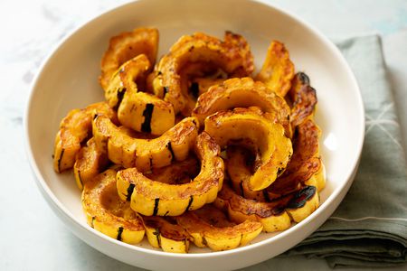 Roasted delicata squash slices in a serving bowl