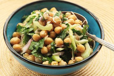Vegan chickpea and cumin salad in a blue and black bowl.
