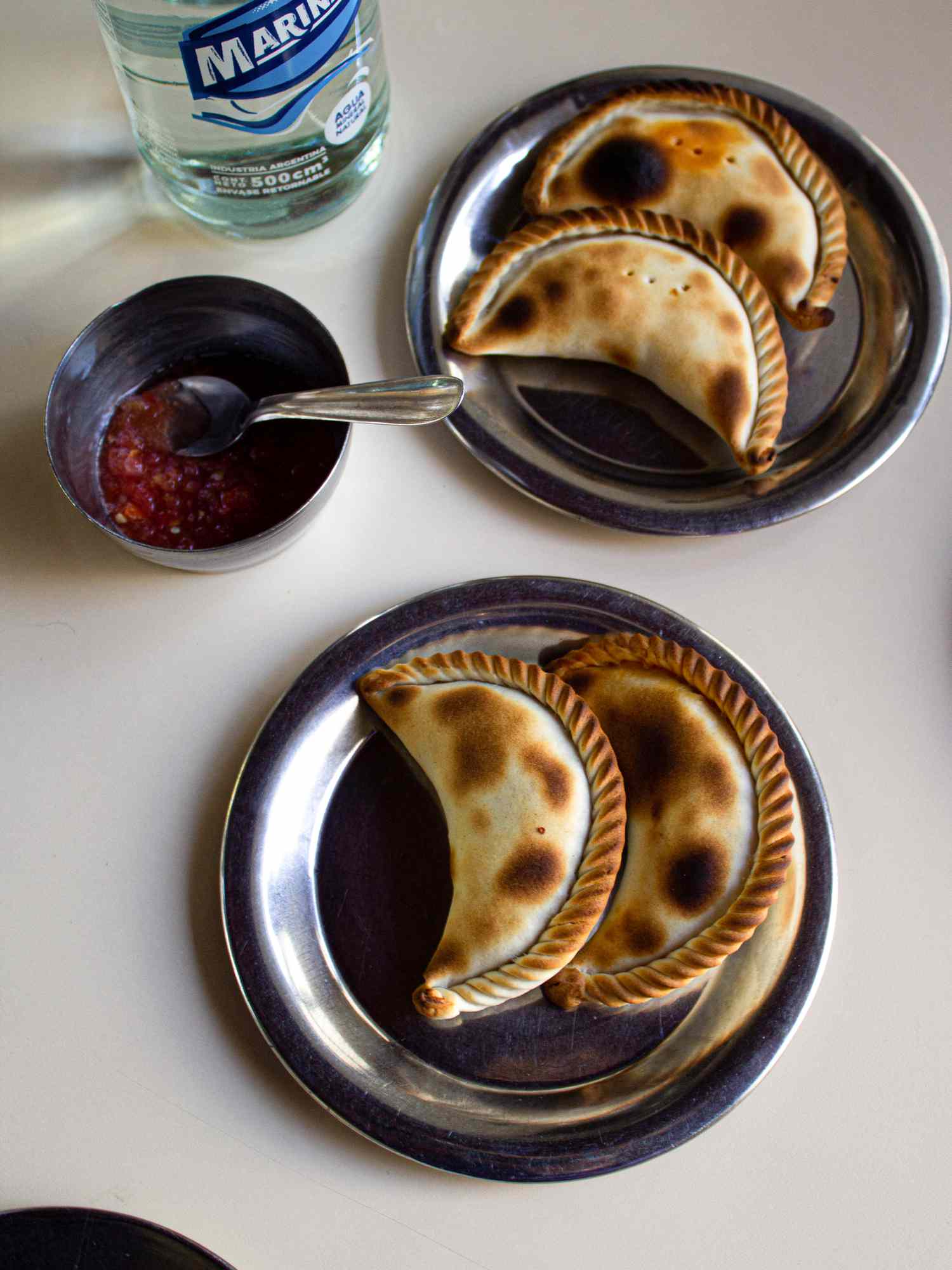 Overhead view of two servings of empanadas
