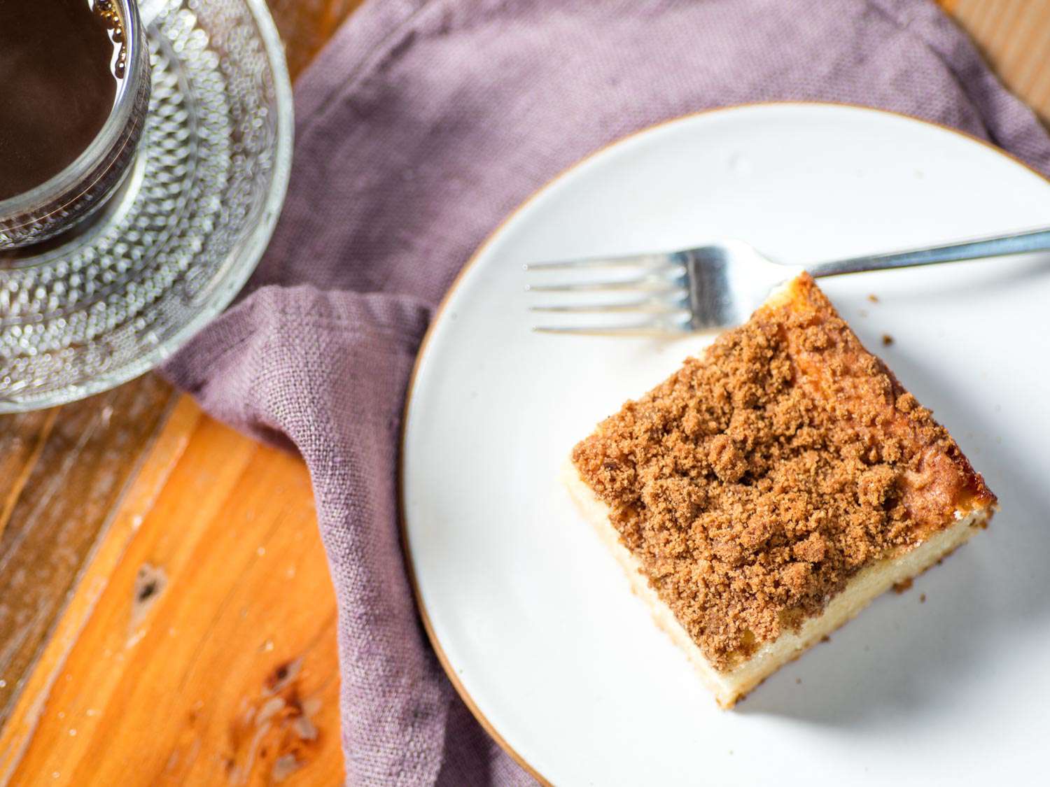 Overhead shot of a square of coffee cake plated with a fork.