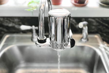 a water faucet filter filtering water
