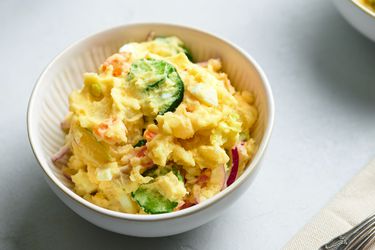 A white ceramic bowl holding Japanese potato salad.