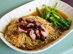 A white dish of wonton mee.