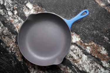 Vintage Le Creuset Enameled cast iron skillet on a black marble backdrop