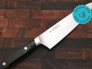 The Misen Chef's Knife on a wooden cutting board