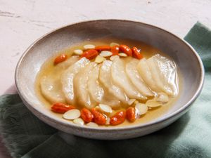 Sliced thawed frozen pears with goji berries and almonds