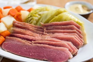 A plate of corned beef, cabbage, potatoes, and carrots.
